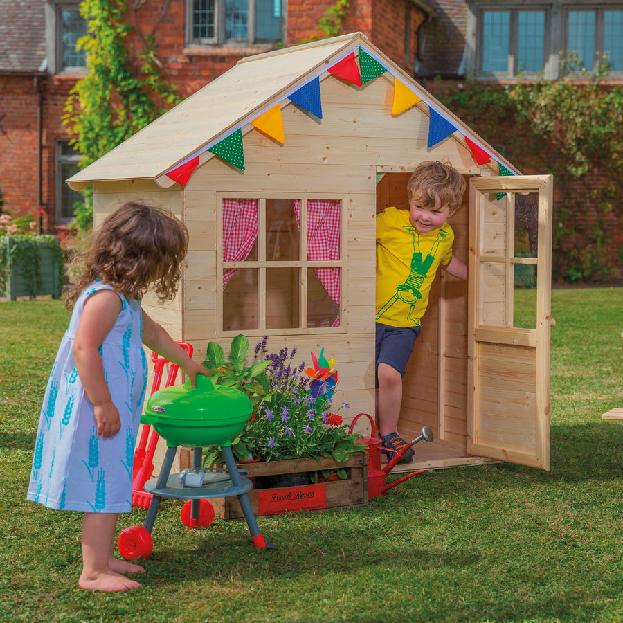 Two children playing in the TP Hideaway playhouse