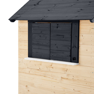 The TP Toys TP Blackberry Cottage Wooden Playhouse - FSC® certified features light-colored plank walls, a closed, dark-painted wooden window, and a matching roof section above.