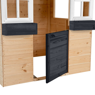 The TP Toys TP Blackberry Cottage Wooden Playhouse - FSC® certified features two window openings, a partially open black door, and a charming exterior of horizontal light wood panels.