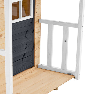 Close-up of a wooden porch with black door, white railing, and window on the TP Toys Bluebell Cottage Wooden Playhouse—FSC® certified—featuring light wood panels for creative play.