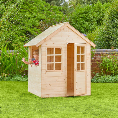 A child waves from the Foxglove Cottage Wooden Playhouse by TP Toys—an FSC® certified wood playhouse with windows and open door, ideal for imaginative garden role play.
