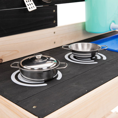 The TP Toys TP Little Chef Wooden Mud Kitchen - FSC® certified features a stovetop with two burners, metal pot and colander, plus a blue plastic sink—ideal for outdoor play adventures.