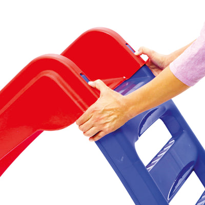 Close-up of hands assembling the TP Toys PalPlay Red & Blue Plastic Folding First Slide, featuring a red top and blue ladder on a white background. This versatile slide is ideal for indoor or outdoor play spaces.