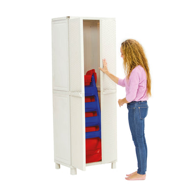 A woman stands barefoot and opens a tall white storage cabinet containing stacked TP Toys PalPlay Red & Blue Plastic Folding First Slides.