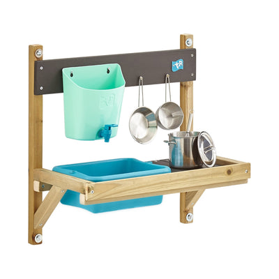 The TP Hideaway Wooden Playhouse with Mud Kitchen by TP Toys features a blue tub, green container, and hanging metal pots and pans—perfect as an outdoor kitchen or mud kitchen. FSC® certified.