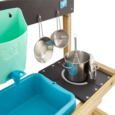 The TP Toys TP Hideaway Wooden Playhouse with Mud Kitchen (FSC® certified) features blue plastic basins, metal pots, pans, whisk, and lid on a wooden frame—ideal for outdoor play in your child’s wooden playhouse.