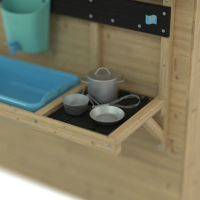 The Lavender Cottage Playhouse with Deluxe Mud Kitchen Accessory by TP Toys features a blue sink, green faucet, and metal cookware on a black countertop—perfect for imaginative play in any wooden playhouse or mud kitchen setup.