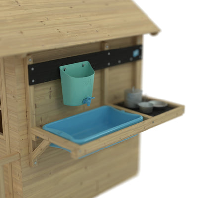 The Lavender Cottage Playhouse with Deluxe Mud Kitchen Accessory by TP Toys features a blue sink, teal wall container, and shelf for toy dishes—perfect for imaginative play and creating mud kitchen adventures. FSC® certified.