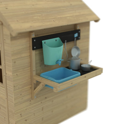 The TP Toys Foxglove Cottage Playhouse with Early Fun Mud Kitchen Accessory and Shutters is made from FSC® certified wood and includes a blue basin, grey pots and pans, plus a teal wall-mounted container.