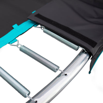 Close-up of TP Toys’ TP 10ft Infinity Round Trampoline springs attached to the metal frame, with safety padding partially covering the springs and a black mat visible, highlighting superior bounce and secure design.