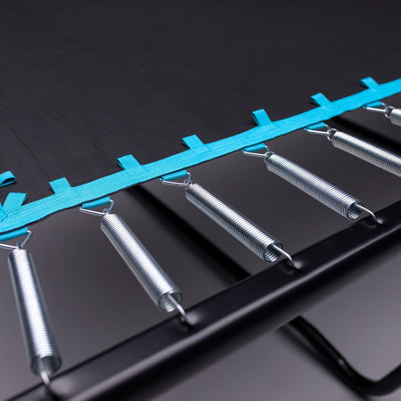 Close-up of metal springs attached to the frame and blue edge of the TP Toys Infinity 8ft x 12ft Rectangular Trampoline, designed for easy assembly.