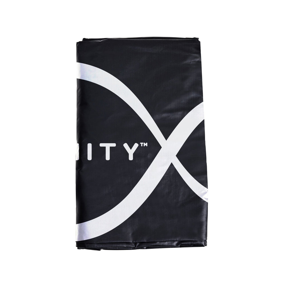 A folded black and white banner featuring a partial infinity symbol and text, perfect as a trampoline accessory like the TP Toys 10ft Infinity Premium Round Trampoline Cover.