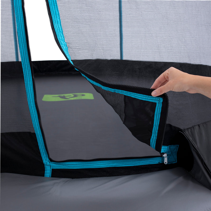 A hand unzipping the entrance of the TP Toys TP Challenger® 8 ft Trampoline, showcasing its patented SurroundSafe enclosure and blue trim for enhanced safety.