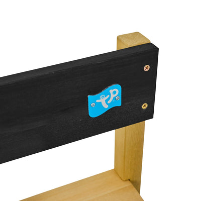 Close-up of the TP Toys TP Junior Chef Wooden Mud Kitchen - FSC® certified, showing a wooden chair with a black backrest, blue sticker with white markings, and visible screws on a white background.