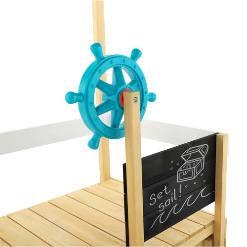 The TP Toys Ahoy Wooden Playboat – FSC® certified – features a blue plastic ship wheel and a chalkboard below with a treasure chest drawing and “Set sail!” text, inspiring imaginative pirate adventures.