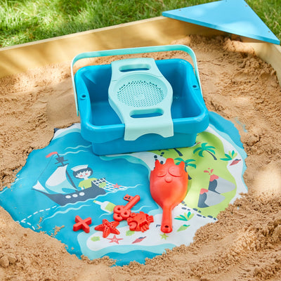 The TP Toys TP Ahoy Wooden Playboat with Dig & Explorer Accessory Kit (FSC® certified) features a blue sandbox sifter and red scoop on a vibrant pirate-themed mat—perfect for creative sand and water play adventures.