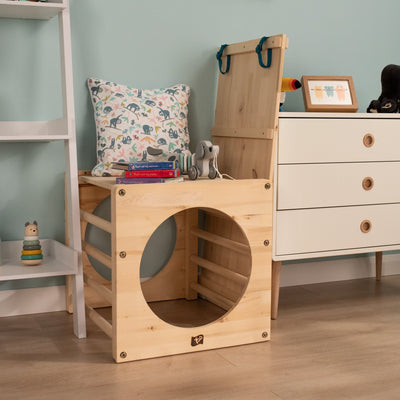 The TP Active-Tots Pikler Style Wooden Climbing Bridge and Slide by TP Toys, FSC® certified, is featured in a childrens room alongside books, toys, and playful decor for creative indoor play.
