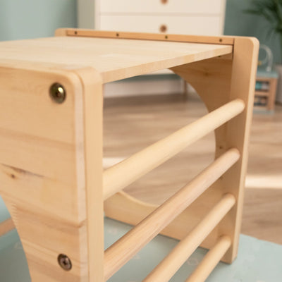 The TP Active-Tots Pikler Style Wooden Climbing Cube by TP Toys is a versatile, FSC® certified piece that serves as both an indoor play table with shelf and a Montessori climbing cube to inspire active, creative exploration.