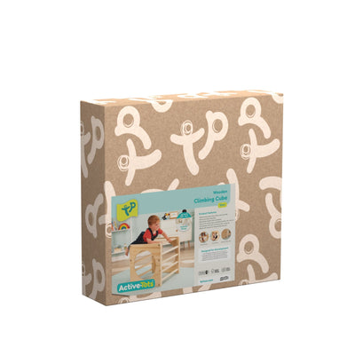 A cardboard box with white patterns and a label showing a child playing with the TP Active-Tots Pikler Style Wooden Climbing Cube - FSC® certified from TP Toys.