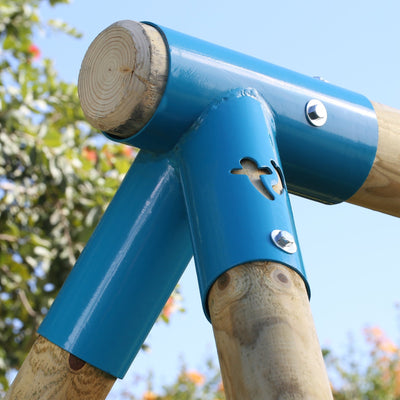 Close-up of the TP Toys TP Sherwood Triple Wooden Swing Set’s wooden frame, joined by blue metal brackets and bolts, set outdoors with trees and a clear sky in the background. PEFC certified.